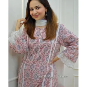 White printed cotton three‑piece kurta set with floral block print, featuring straight kurta, matching sharara palazzo and coordinating dupatta laid out on wooden floor