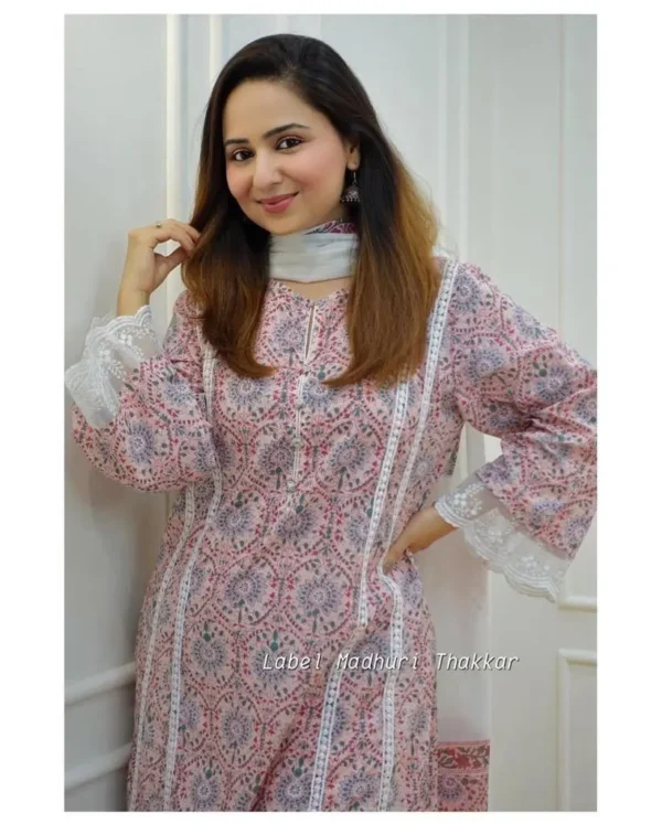 White printed cotton three‑piece kurta set with floral block print, featuring straight kurta, matching sharara palazzo and coordinating dupatta laid out on wooden floor