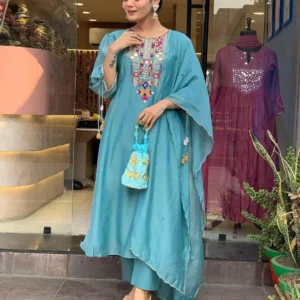 Woman wearing white kurta set with colorful embroidery and sheer dupatta – festive ethnic outfit