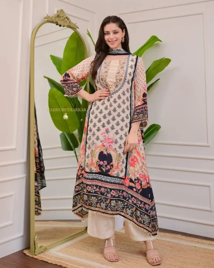 Woman wearing yellow-red printed kurta with mirror work and navy plazzo – festive Indian ethnic outfit