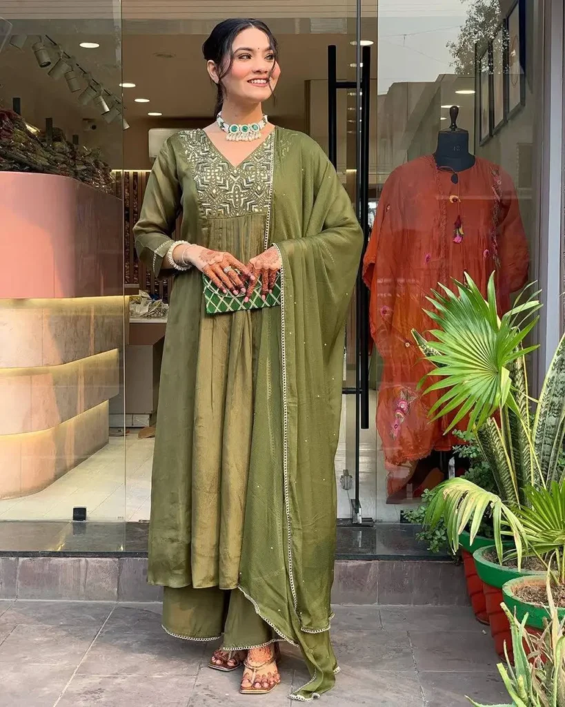 Woman wearing olive green embroidered kurta set with sequin detailing and matching dupatta – festive Indian ethnic wear