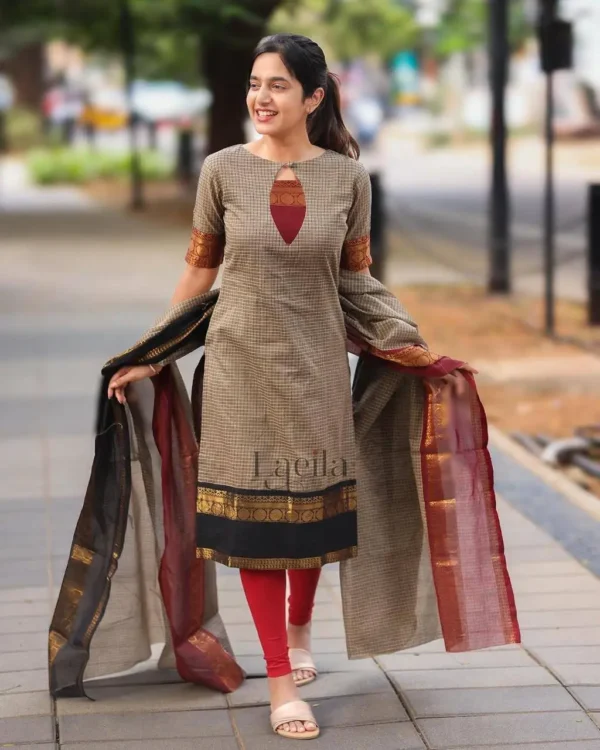 Woman wearing a checked cotton kurta with red leggings and silk dual-tone dupatta outdoors