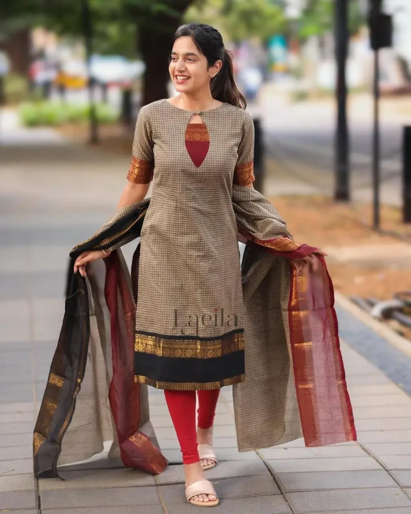 Woman wearing a checked cotton kurta with red leggings and silk dual-tone dupatta outdoors