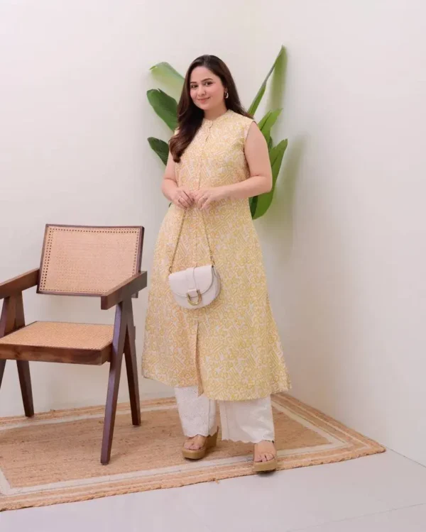 Woman posing in a pastel yellow sleeveless kurti featuring geometric prints and palazzos