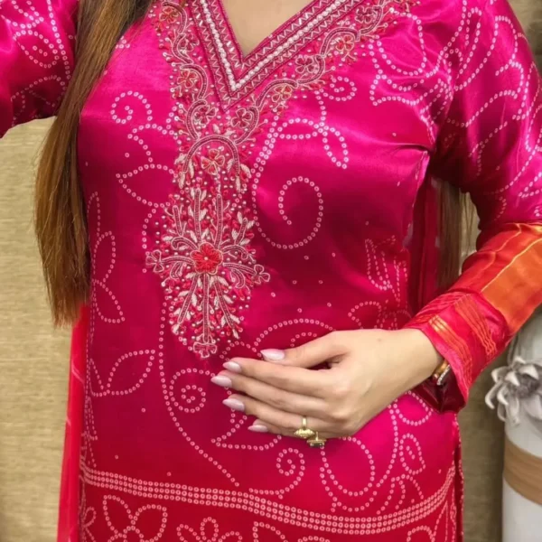 Bright pink three-piece ethnic set with dupatta and golden sleeve detail